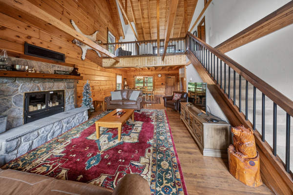 View from the patio doors looking in on the spacious family room with plenty of seating and RokuTV.
