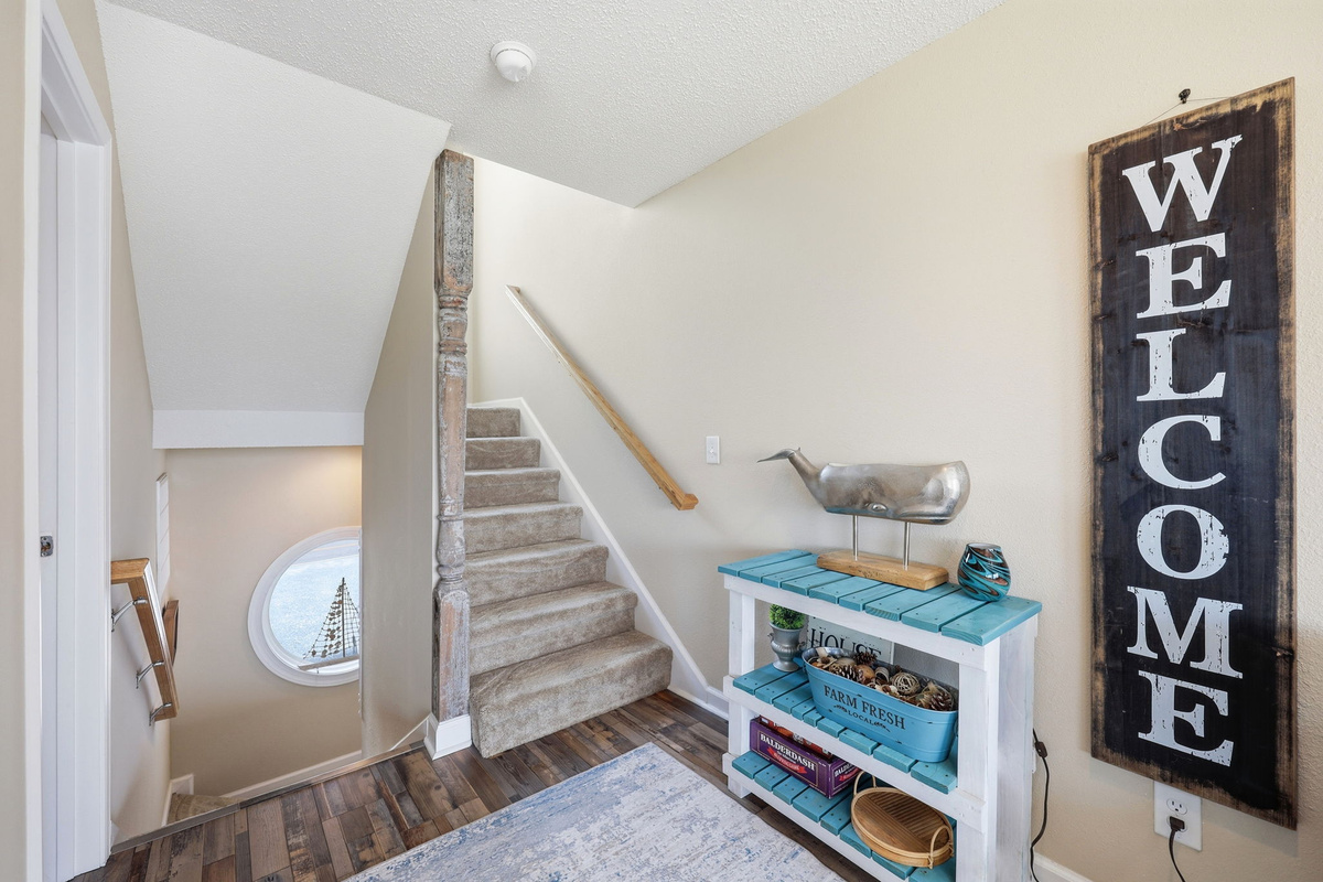 Coastal decor and rustic charm create a warm, welcoming retreat. Head upstairs to the king suite and the coolest hangout!