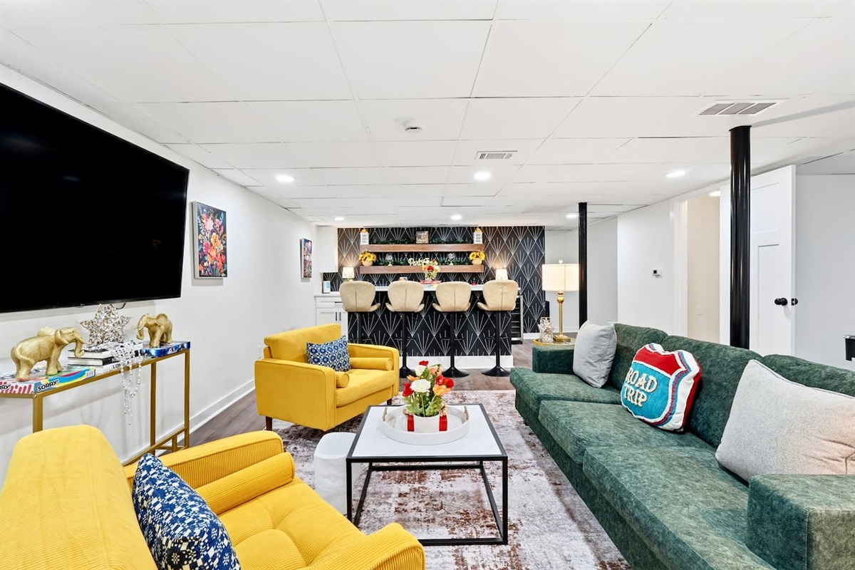 Amazing game room located in the basement, featuring a pool table, foosball table, and a stylish bar perfect for entertaining and relaxing with friends and family.