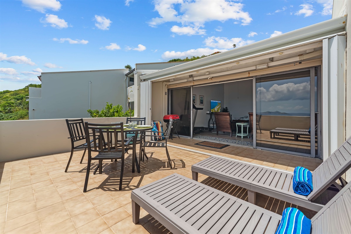 Huge sliding doors in the living room open up to a spacious patio with incredible views of the sunrise each morning.