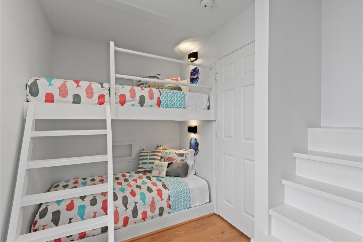 The Whale bedroom located on the second floor features playful and functional 2 built-in Twin over Twin Bunk Beds, creating a lively atmosphere for younger guests, complemented by its own Smart TV.