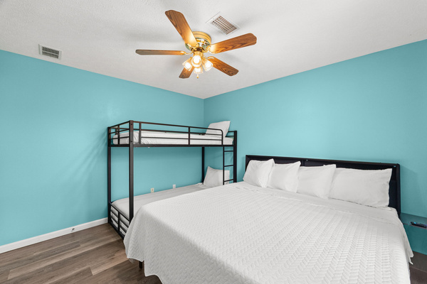 Stay fully connected in the Sea Wave Room! This setup features a comfortable king bed with a stylish headboard and an adjacent side table—complete with built-in USB, USB-C, and 120V charging ports right at your fingertips for effortless device charging. 