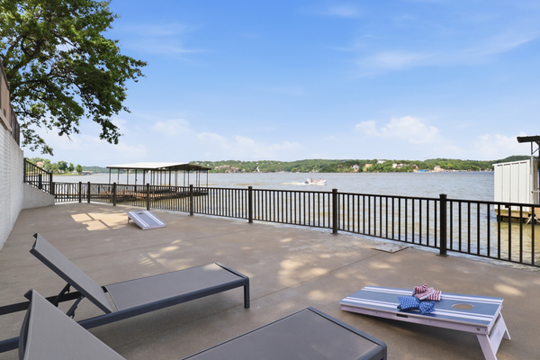 Lower level martini deck with sun chairs and a great place to setup games