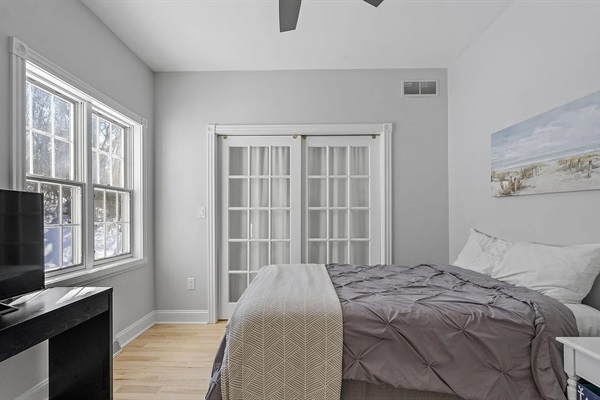 Comfortable first-floor bedroom with nearby bathroom access, offering easy convenience for guests who prefer main-floor living.