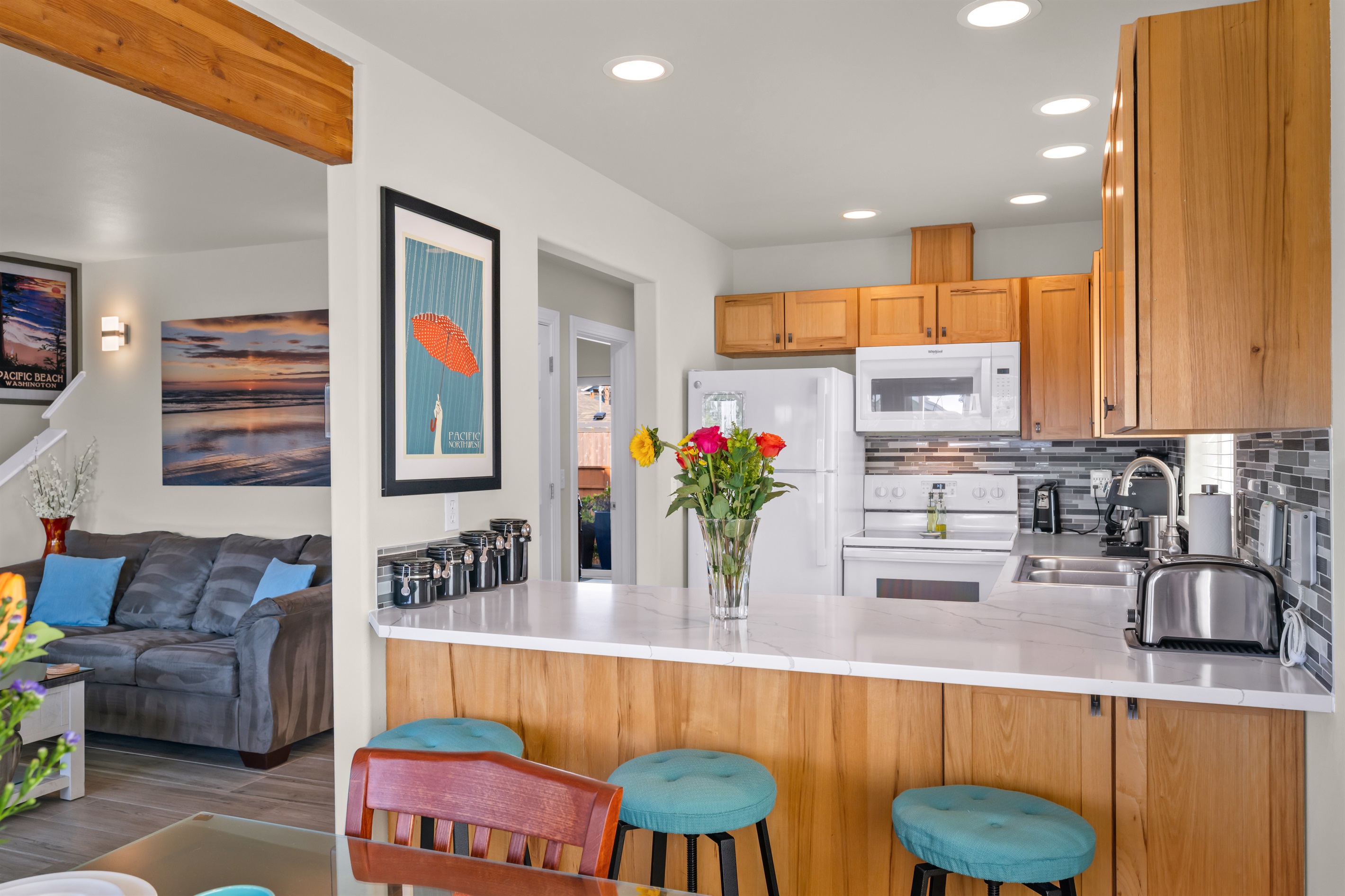 Fully-stocked kitchen with stainless steel cookware and supplied staples