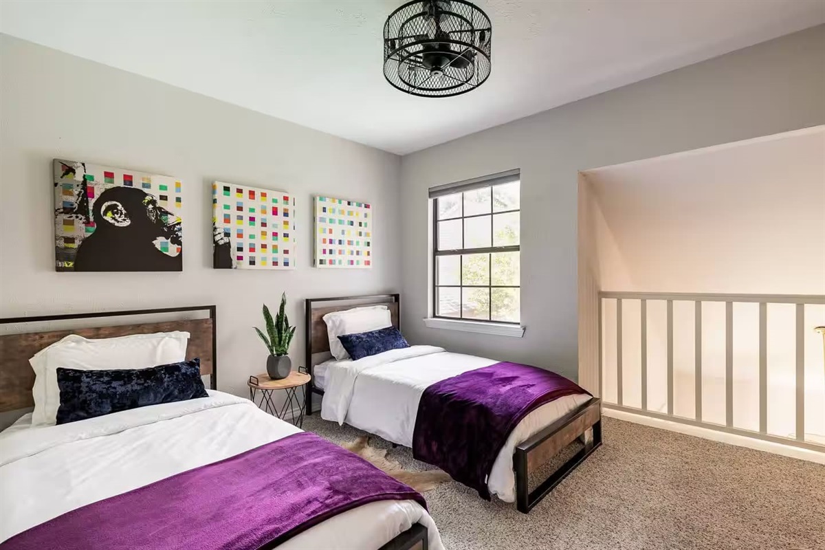 Guest bedroom with twin beds and modern comfort.
