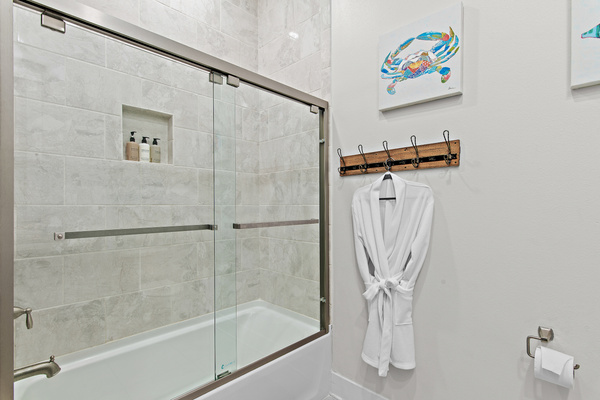 Modern, full-featured guest bathroom featuring a spacious shower and ample vanity space, conveniently located near the guest rooms for easy access and privacy.