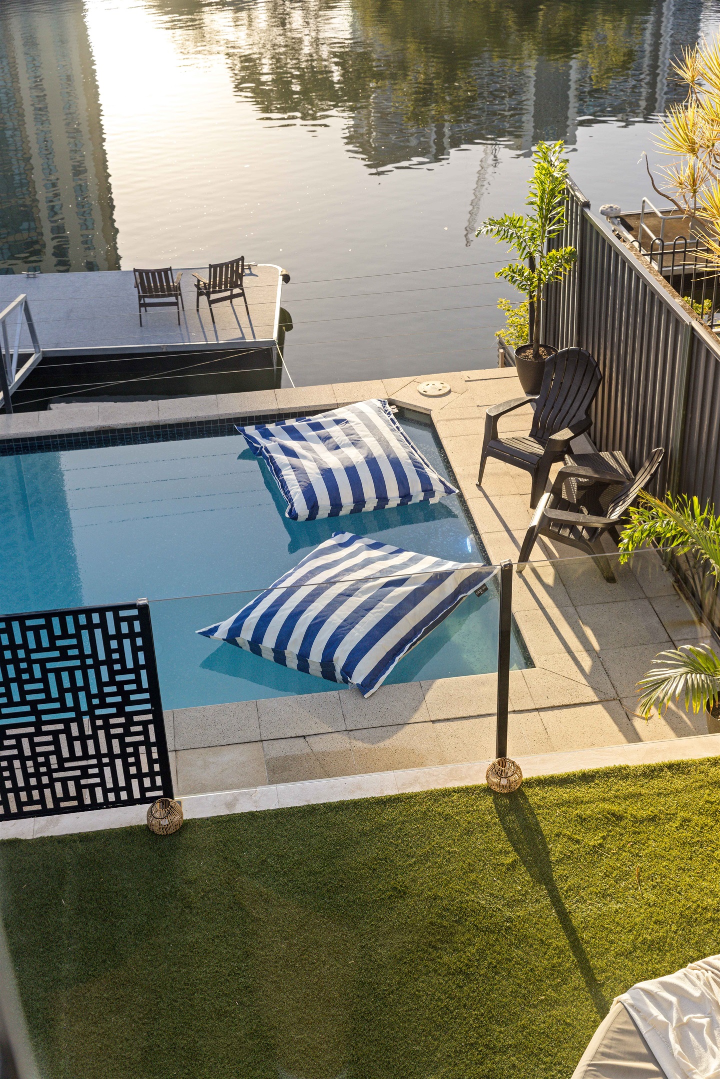 Resort-style pool overlooking the canal with the Gold Coast skyline beyond.