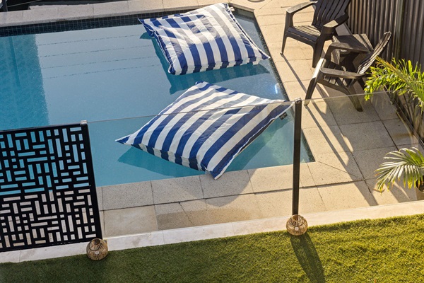 Resort-style pool overlooking the canal with the Gold Coast skyline beyond.