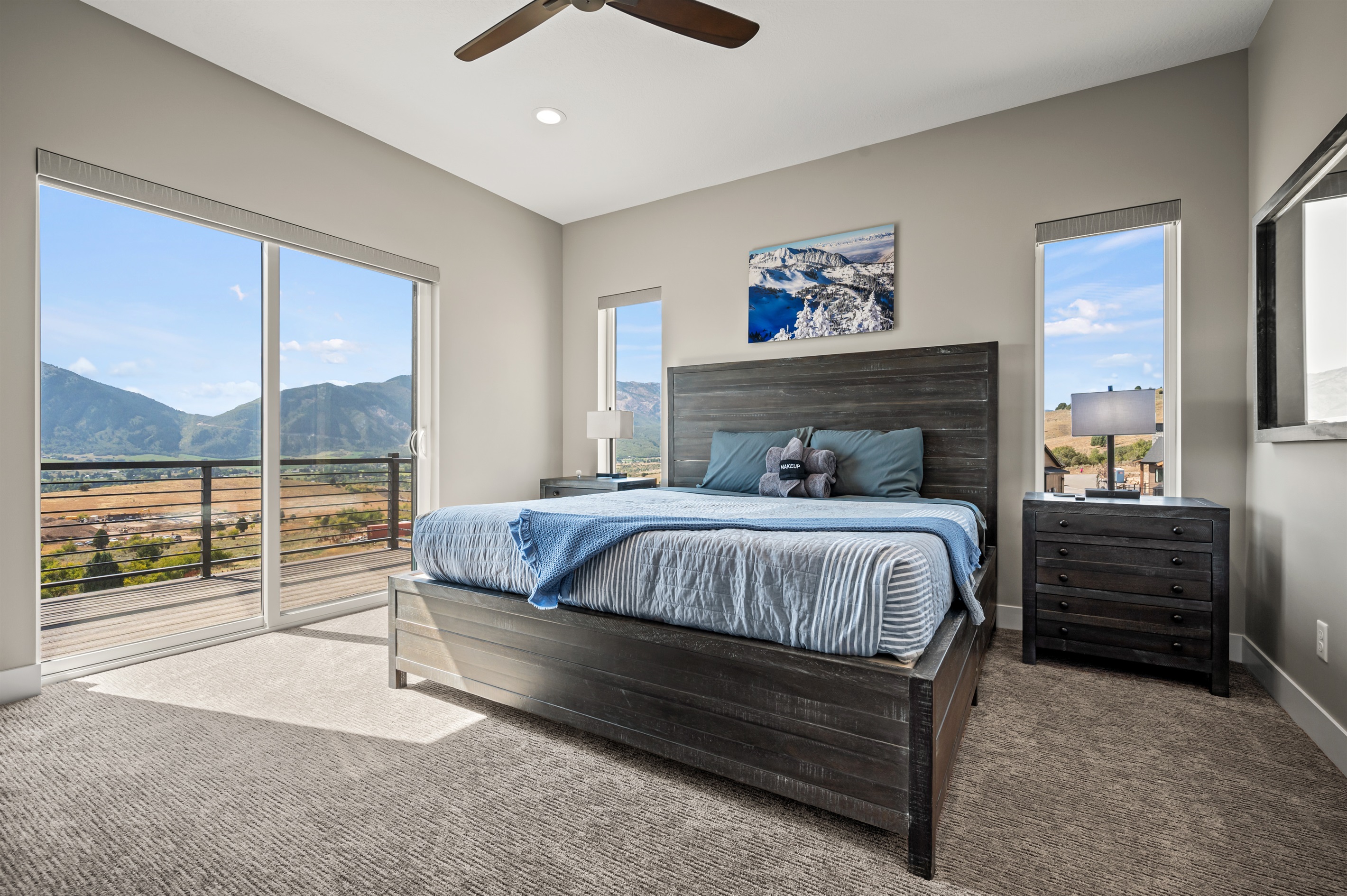 Primary king suite with balcony access and panoramic mountain scenery