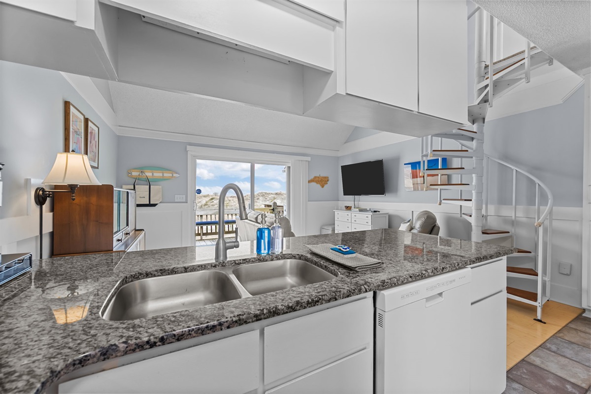Open-concept kitchen with granite counters&mdash;perfect for cooking, chatting, and keeping an eye on the living space
