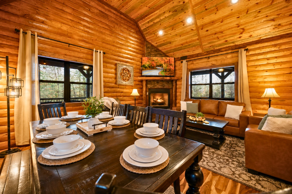 Shared meals become part of the experience in this inviting dining area surrounded by warm lighting and cabin charm.