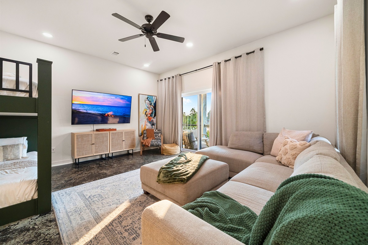 Downstairs lounge area with sectional seating and Smart TV&mdash;perfect for movie nights or group hangouts.