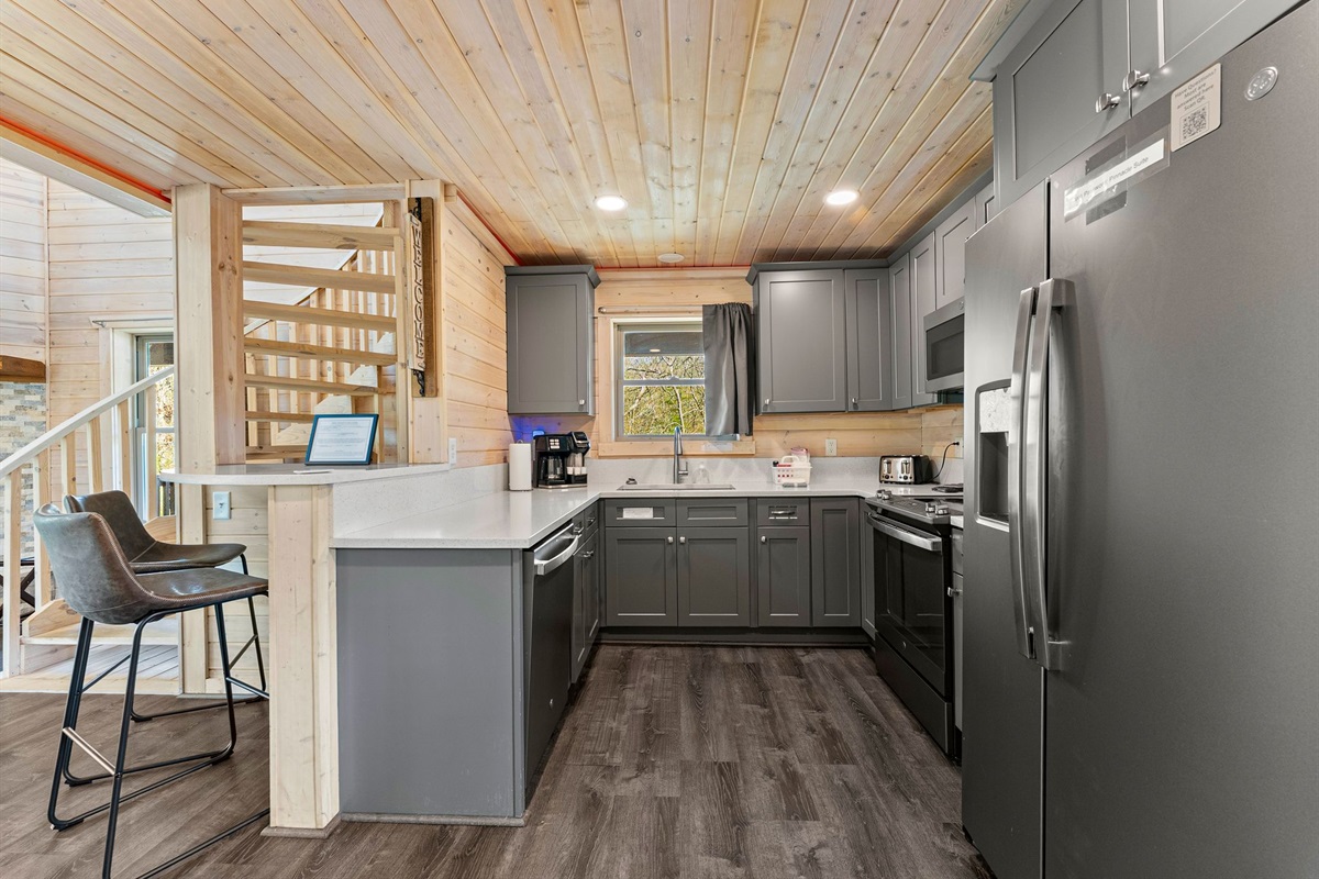 Kitchen with Quartz Countertops and Full-Size Refrigerator
