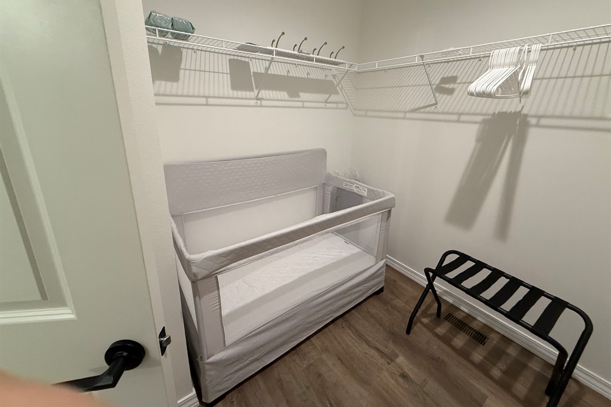 Master bedroom closet contains crib and pak n play 