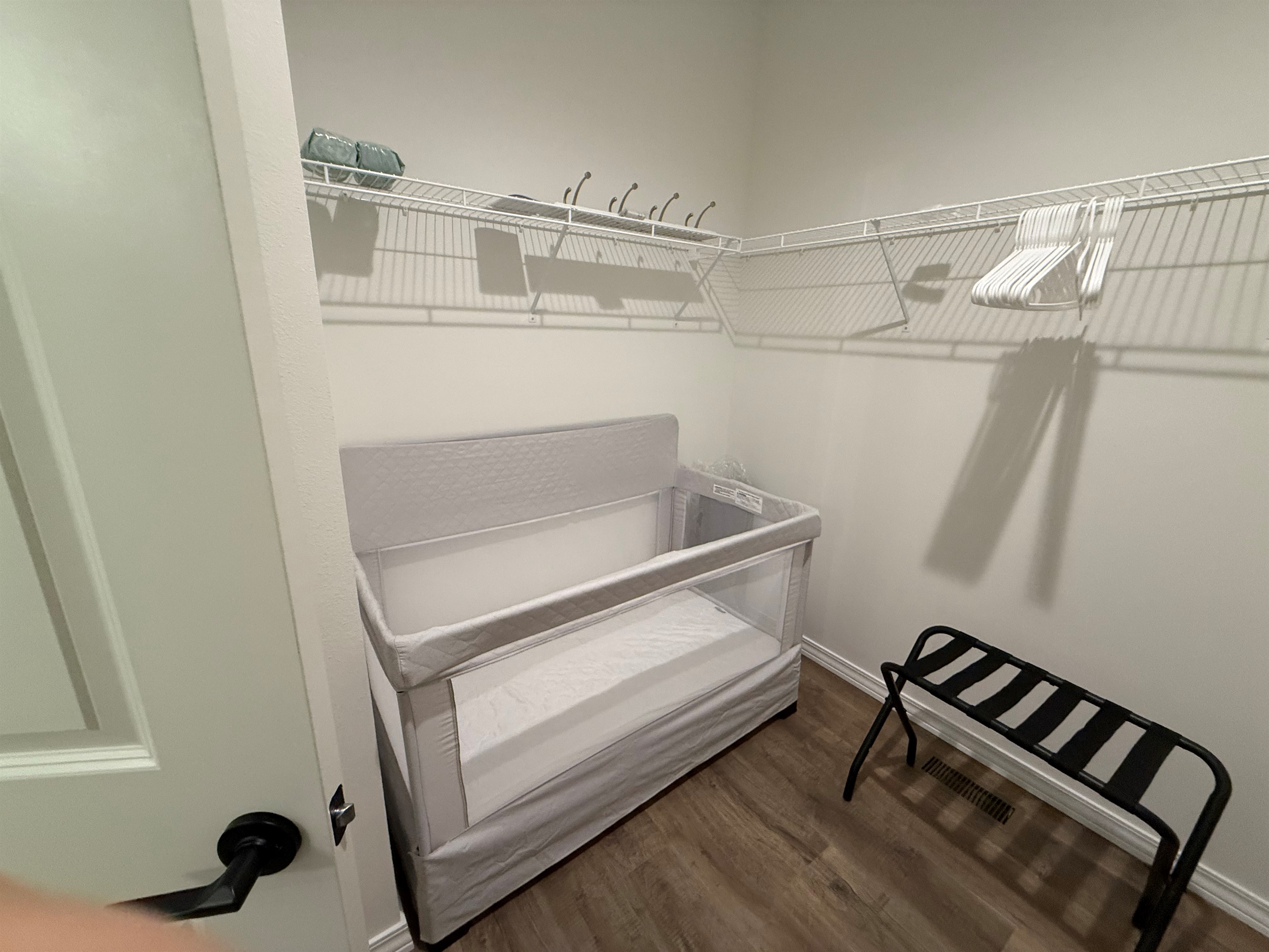Master bedroom closet contains crib and pak n play 