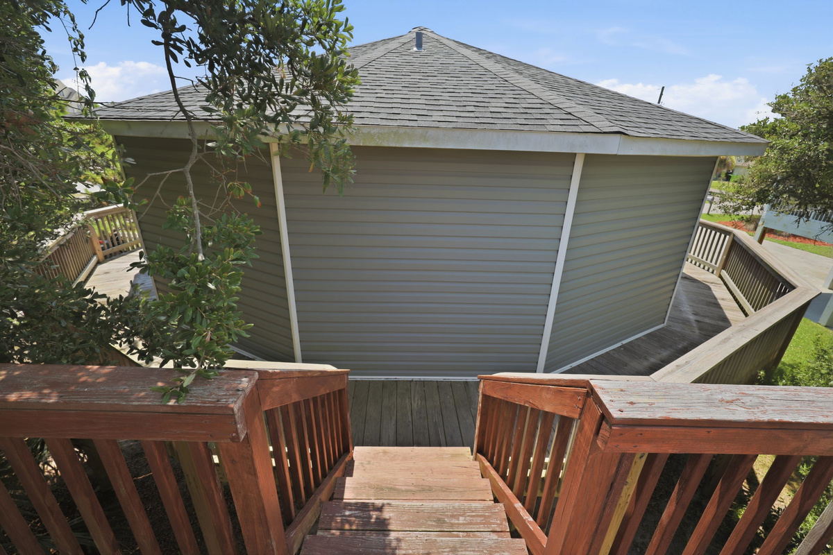 Convenient stairs connecting the wraparound deck to the spacious upper sun deck