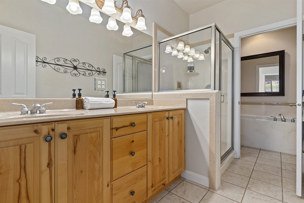 A spa-inspired primary bathroom with dual vanities, elegant finishes, and thoughtful design for a refined daily routine.