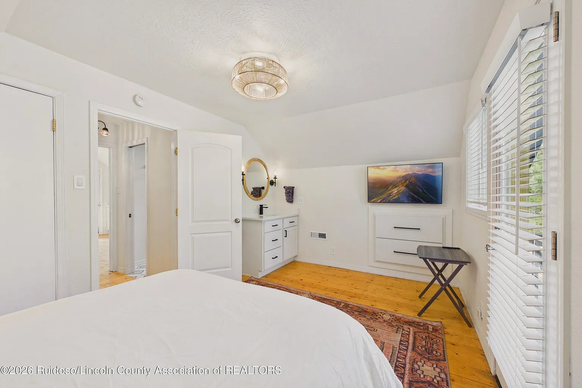 Upstairs bedroom with TV and private balcony