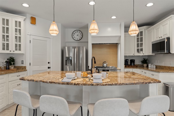 Spacious gourmet kitchen, fully equipped with a 6-burner range for culinary enthusiasts and 4 bar seats at the kitchen island for additional dining options