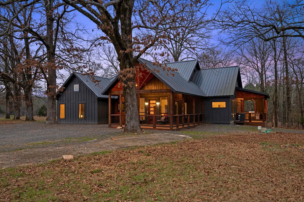 Evening light and warm cabin glow make this exterior view feel extra cozy, setting the tone for a relaxing night in.