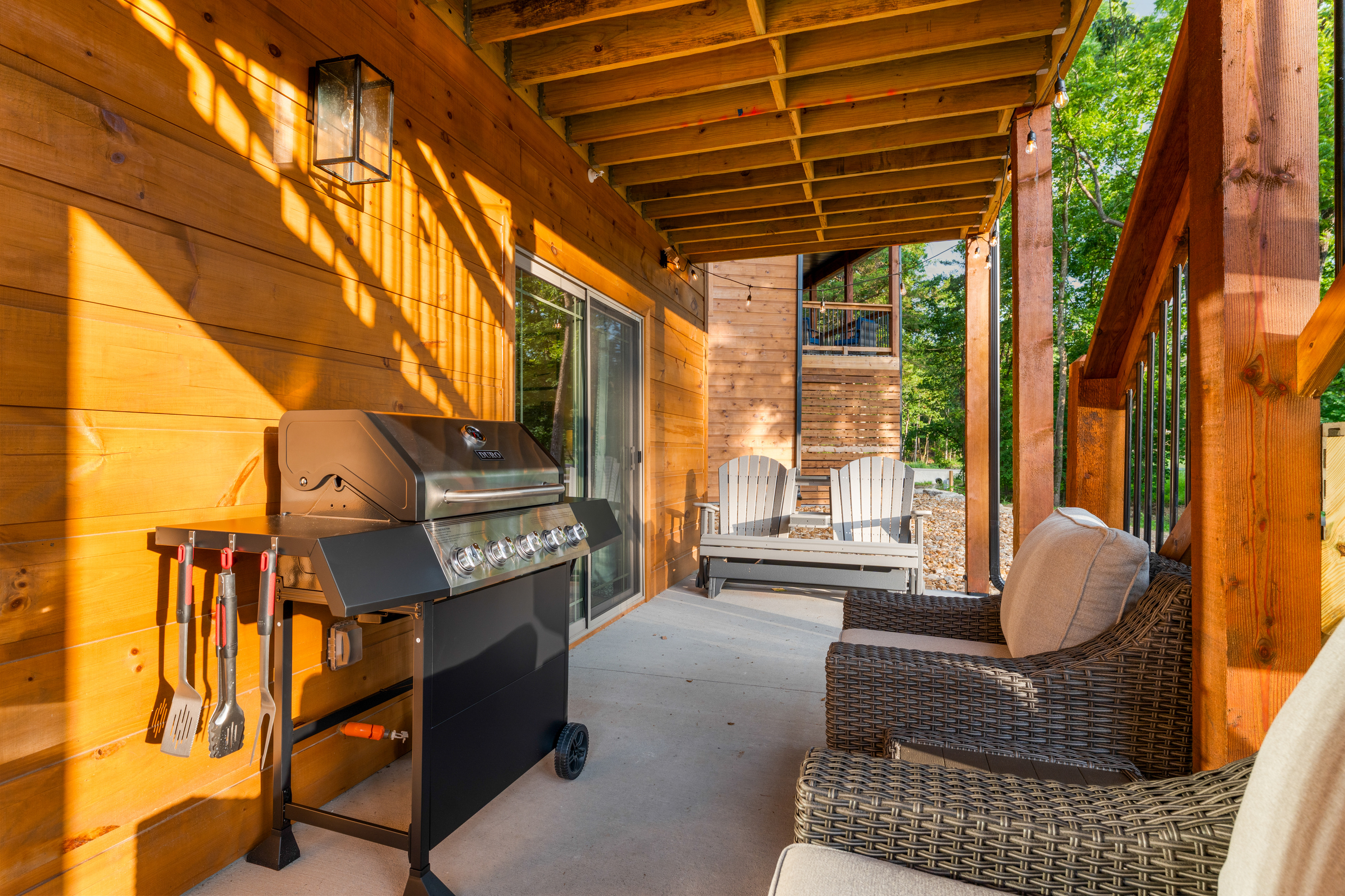 Fire up the gas grill and pull up an Adirondack chair on the covered lower patio.