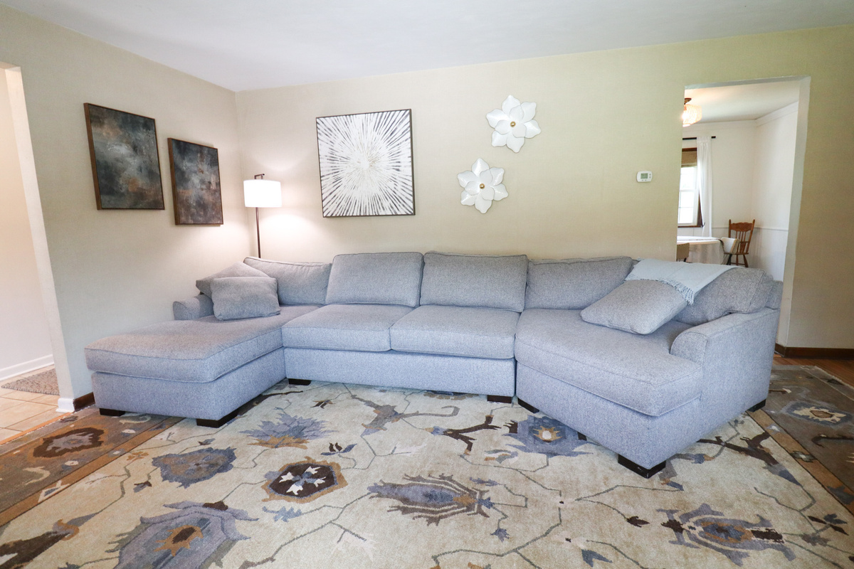 Spacious living space with comfortable couches and large screen tv