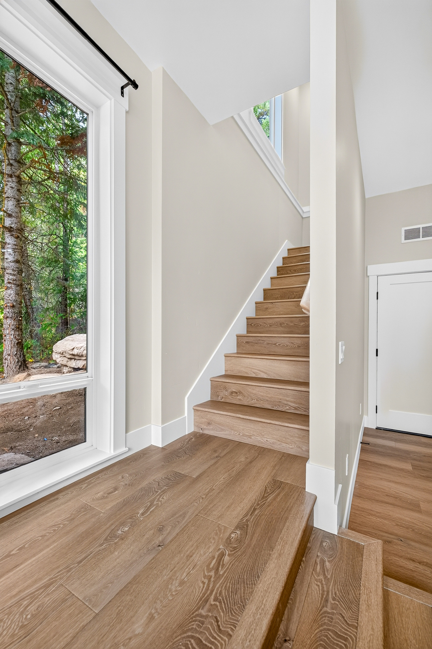 Stairway to primary suite and back patio.