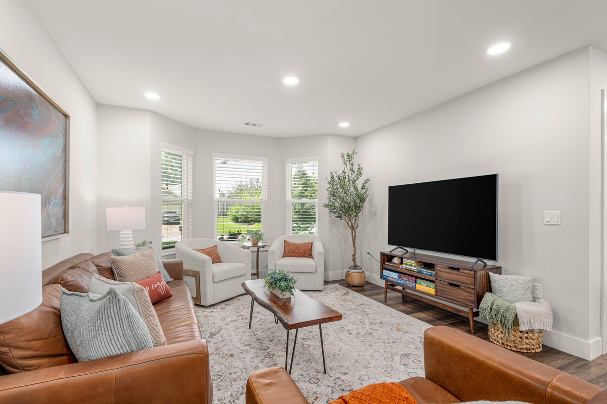 Relax after a day of adventure in the cozy living room with comfortable seating and a 65-inch Smart TV.