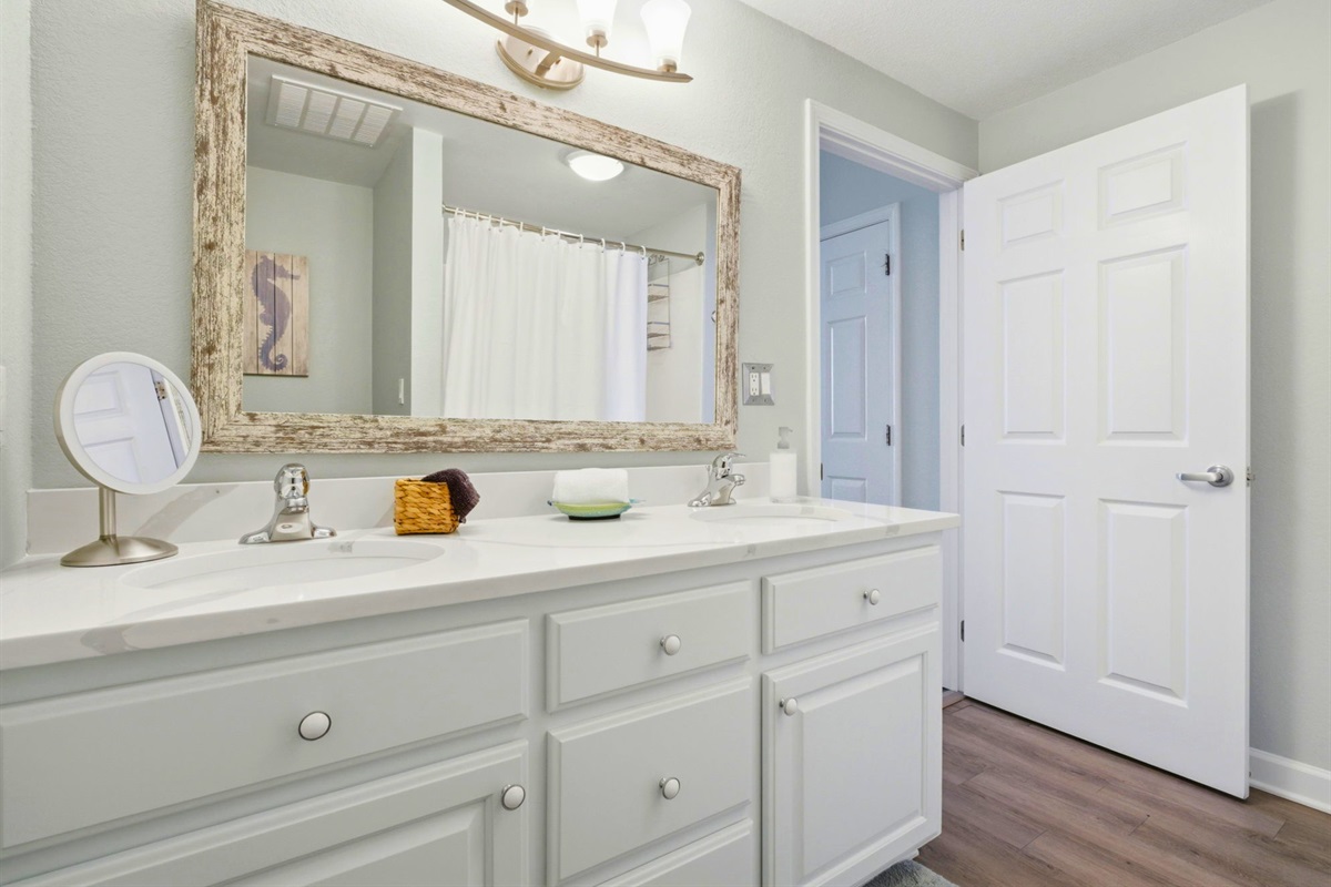 Featuring dual vanities and plenty of storage space, the primary bathroom offers both convenience and comfort.