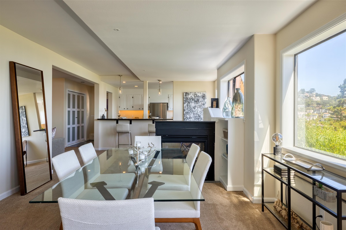 Dining table lit by the glow of the three-sided fireplace