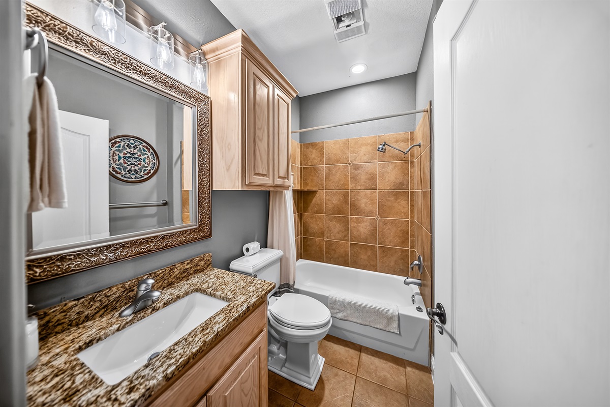 Full bathroom with a tub and shower combo.