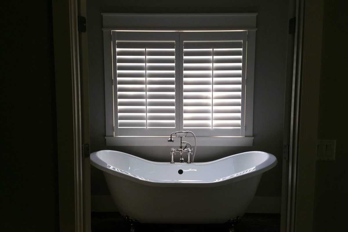 Clawfoot tub and shower in upstairs bathroom of cottage rental