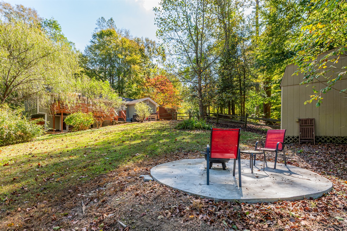 Charming Outdoor: Relax in vibrant red chairs as nature surrounds you in serene Quinton!