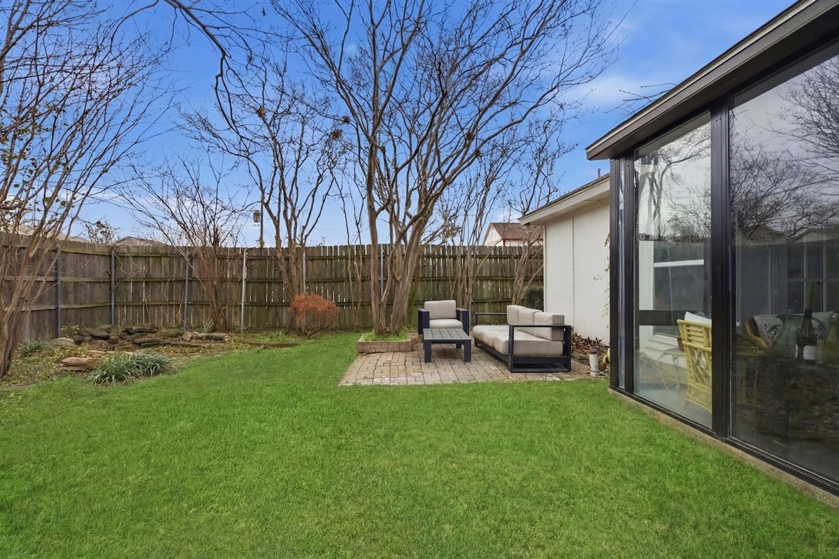 Private fenced yard with patio seating and peaceful surroundings for morning coffee or evening downtime.