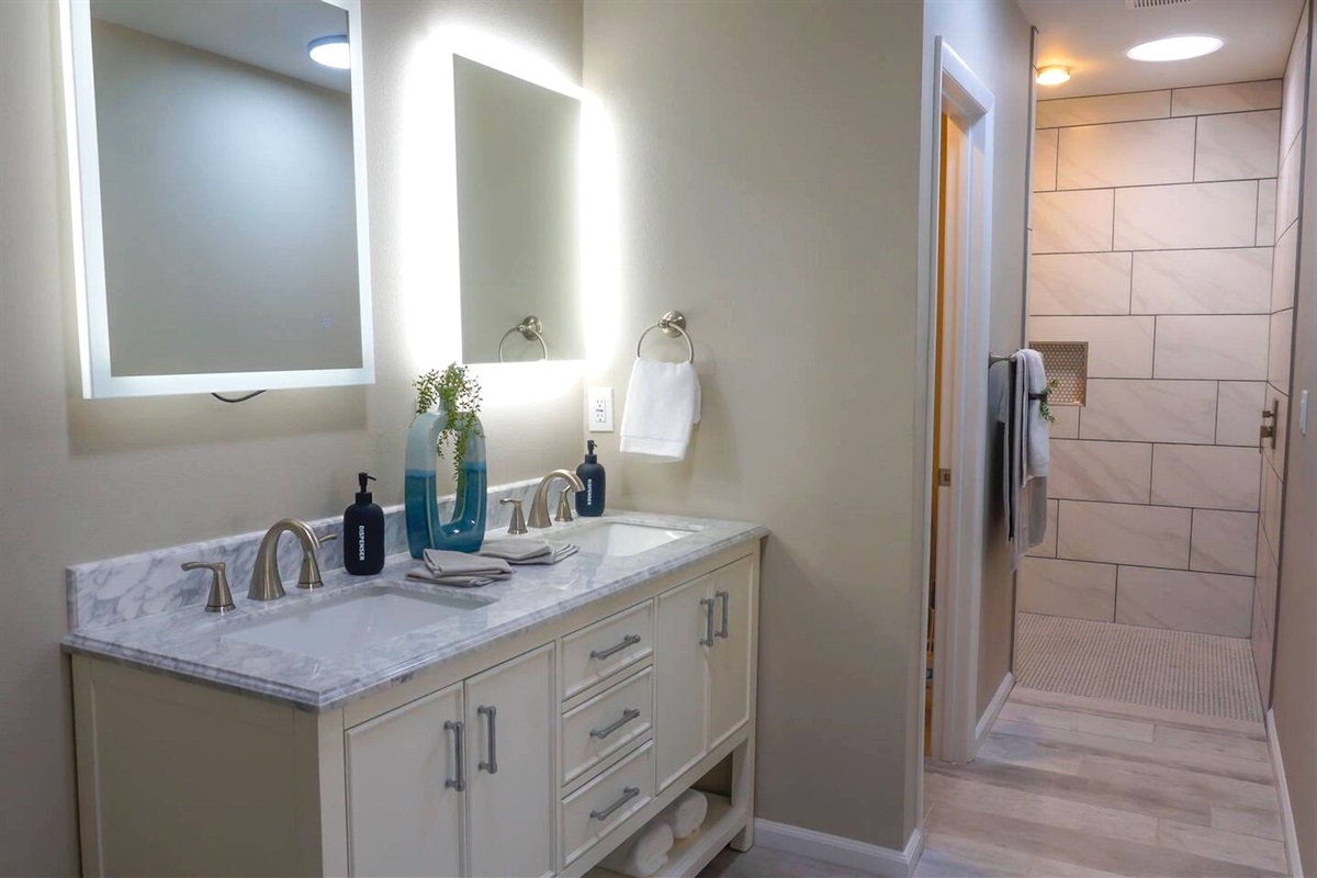 The primary bath has double vanity sinks and a walk-in shower.
