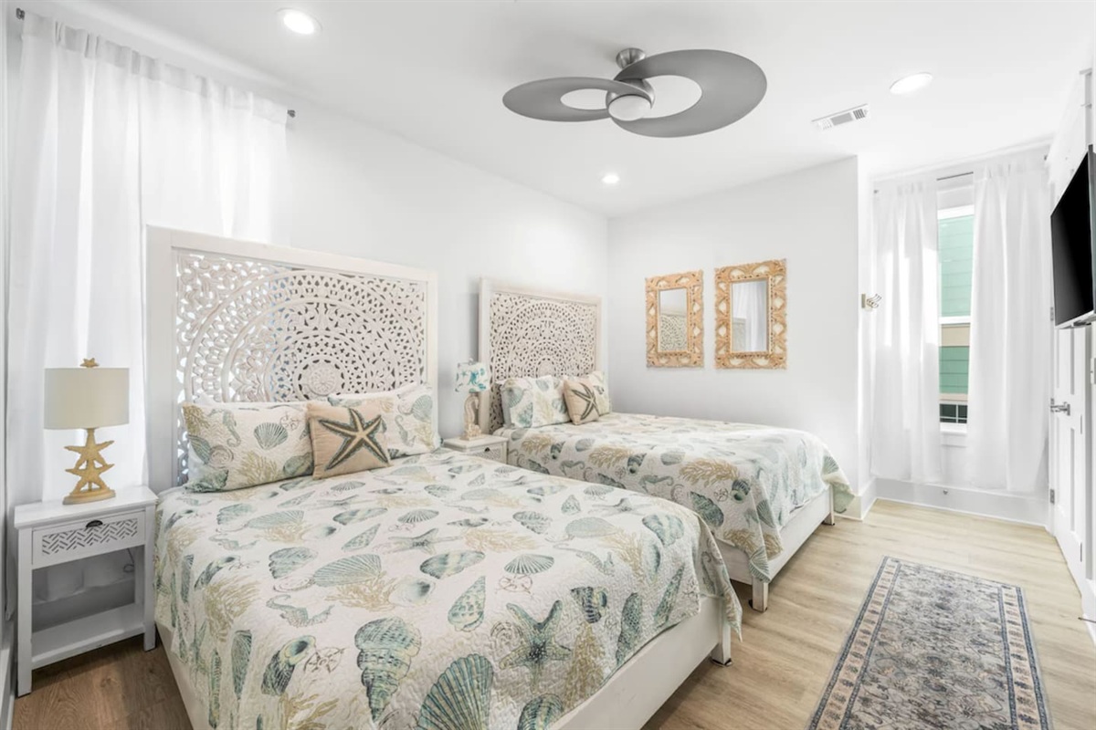 Experience 30A luxury in this serene guest suite featuring two unique Balinese-carved Queen beds.  Catch your favorite shows on the Smart TV and stay cool with the high end customer set AC and Supersonic fan  Includes an adjoining bathroom
