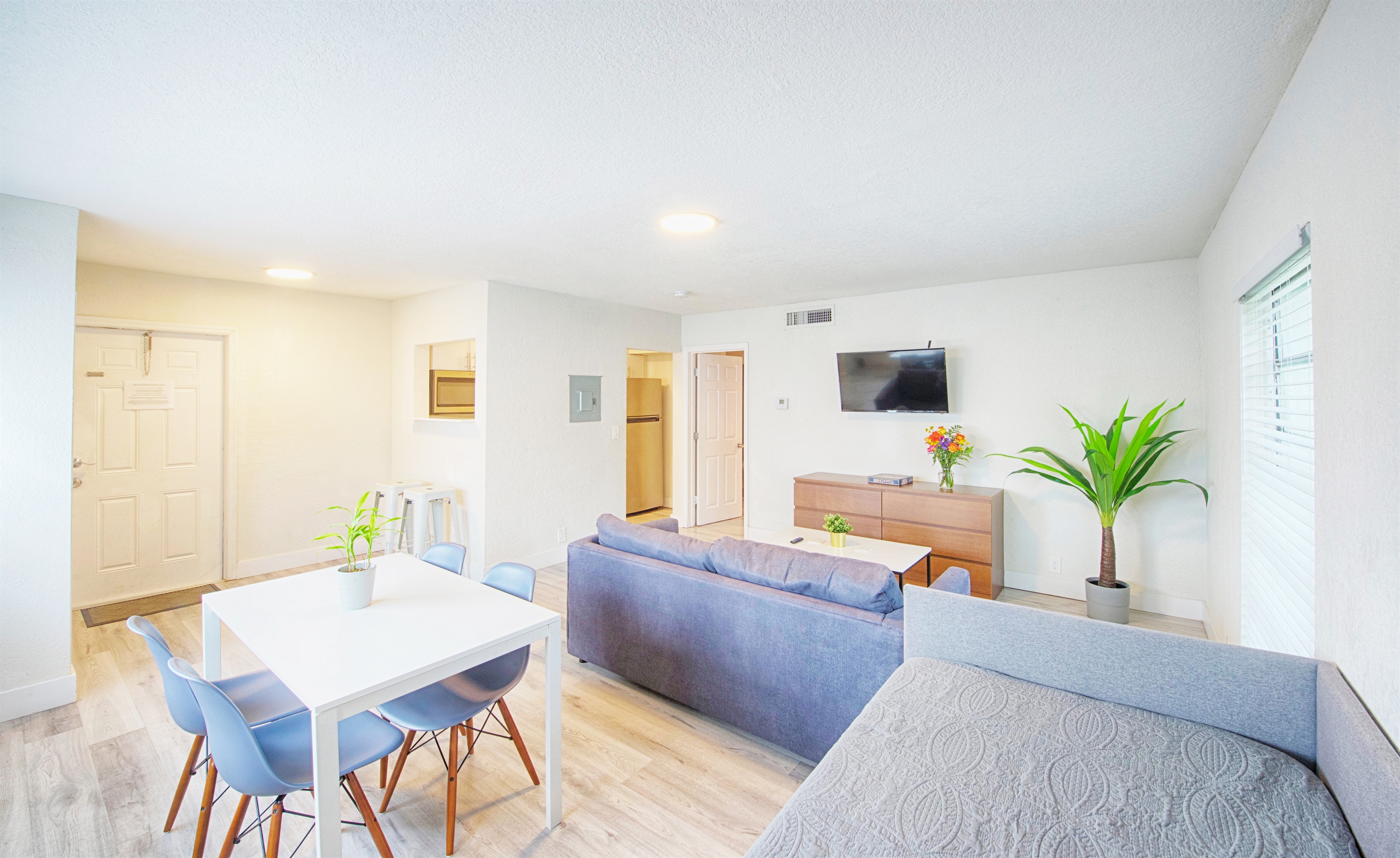 Featuring dining table for 4, day bed and sofa with queen pull out bed inside. Apartment entry in view.