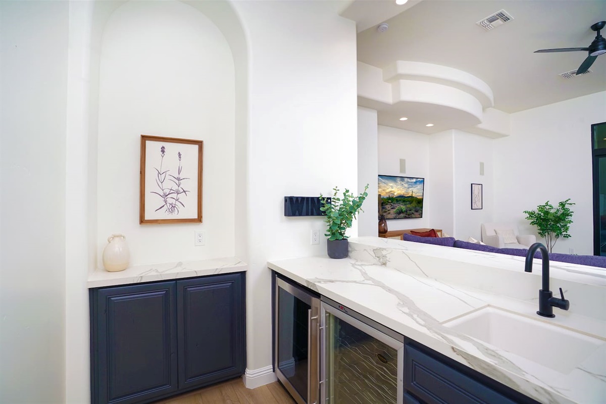 Wet bar located directly off kitchen/living room complete with multiple temp wine coolers & sink.
