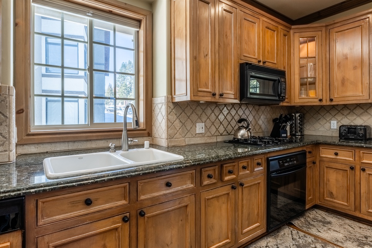 The Charming Chalet's light-filled kitchen with modern appliances, designed for easy and enjoyable cooking.