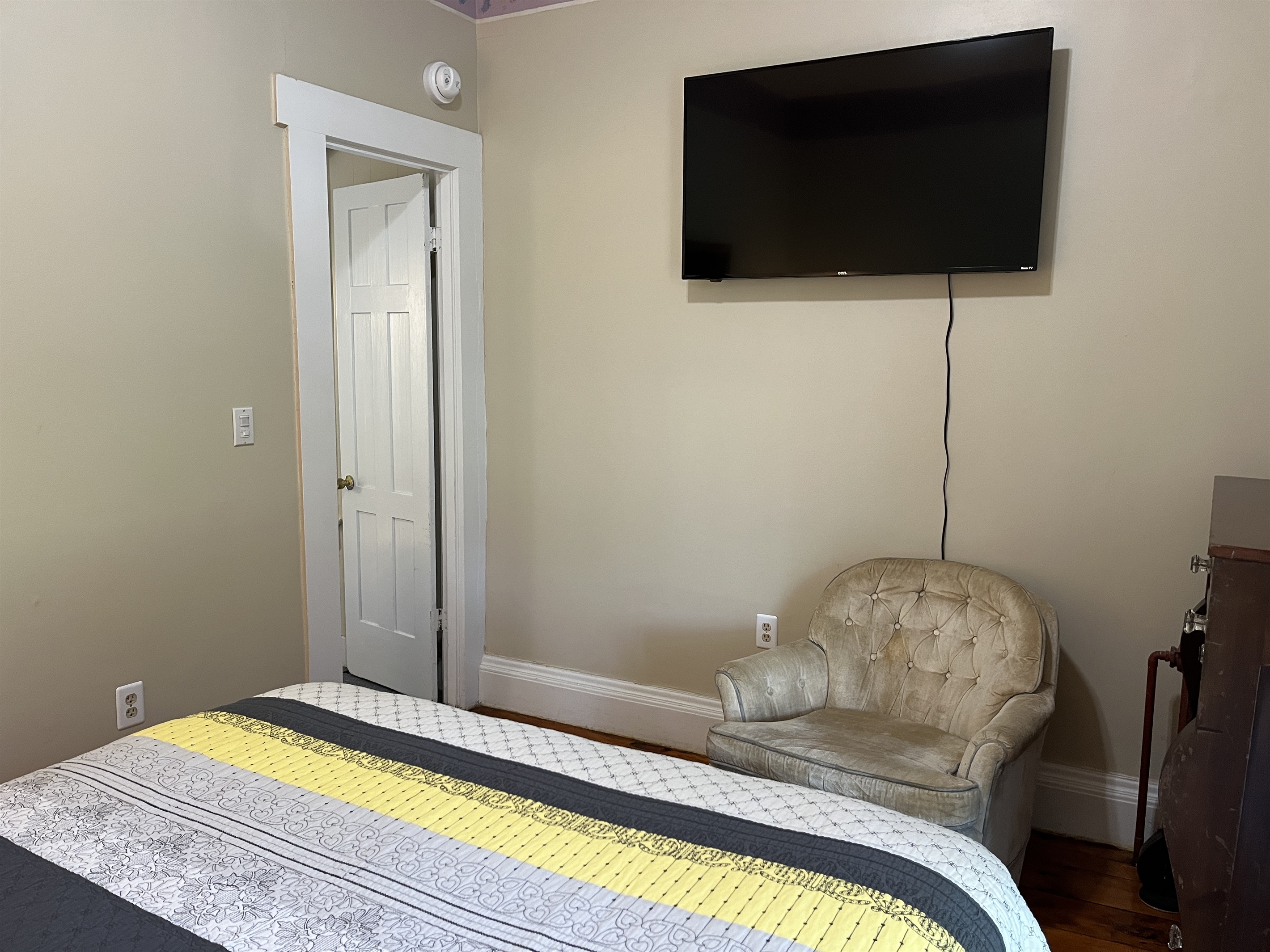 1st floor bedroom #2  w/ TV. The door leads to the outer room.