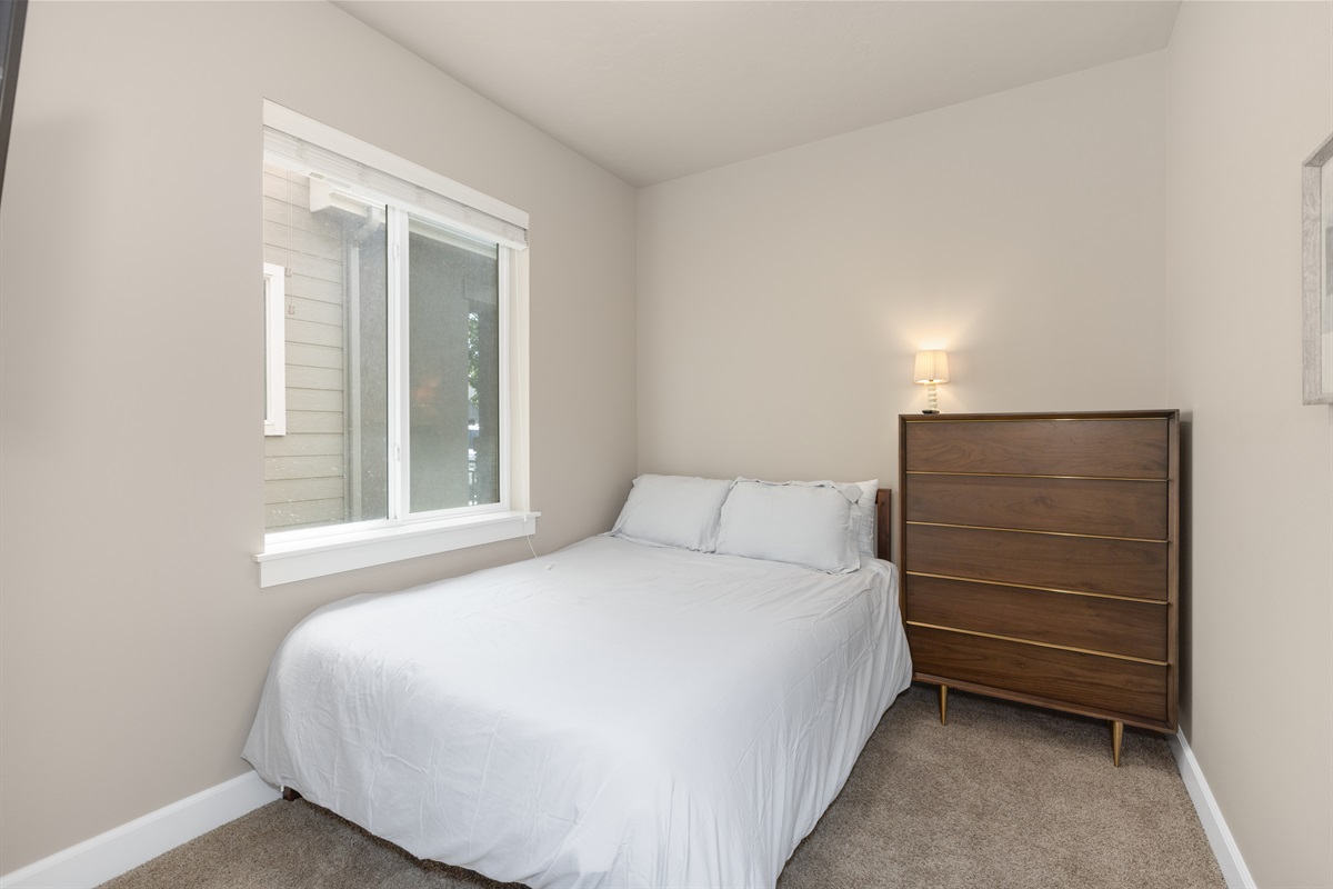 Peaceful queen bedroom with plenty of natural light