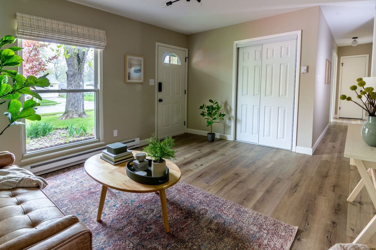 Layered rugs and soft styling give the living area a collected, comfortable character.