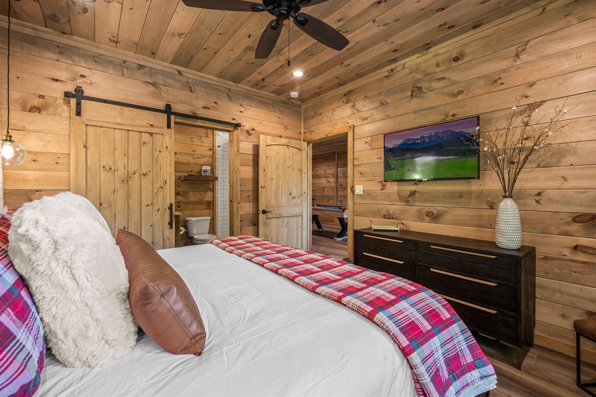Lower level suite has a King Bed, dresser, and smart TV. 