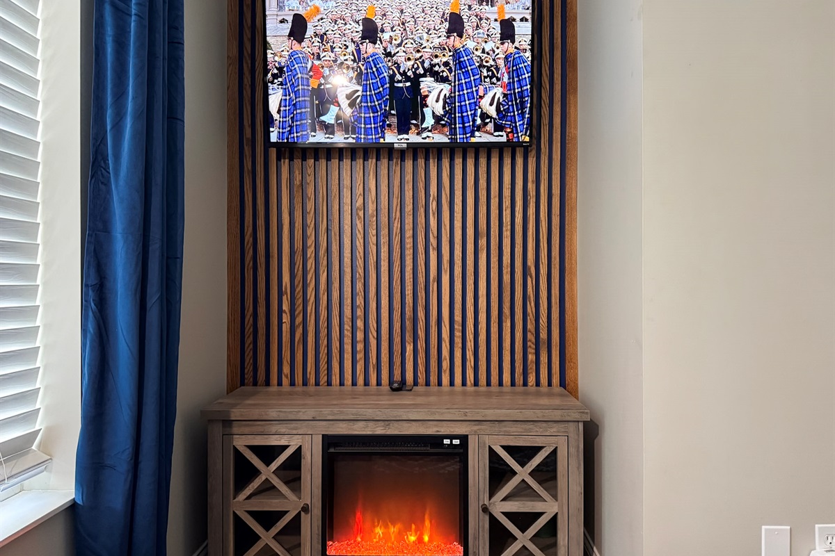 SmartTV with Cozy Fireplace in Lower Bedroom