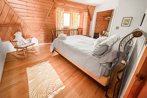 Bedroom with queen bed and window