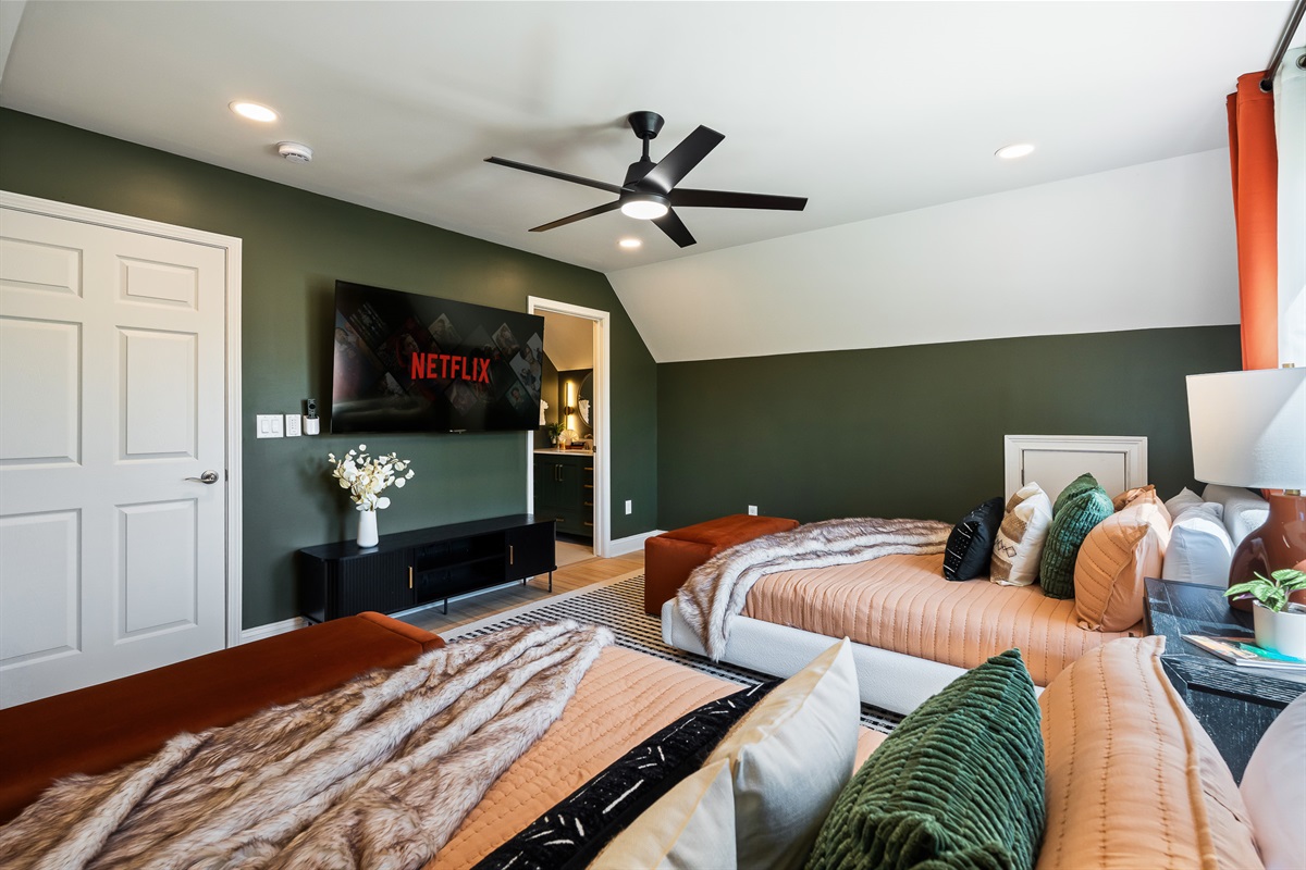 Bedroom with TV and multiple beds - perfect for relaxing without leaving your room