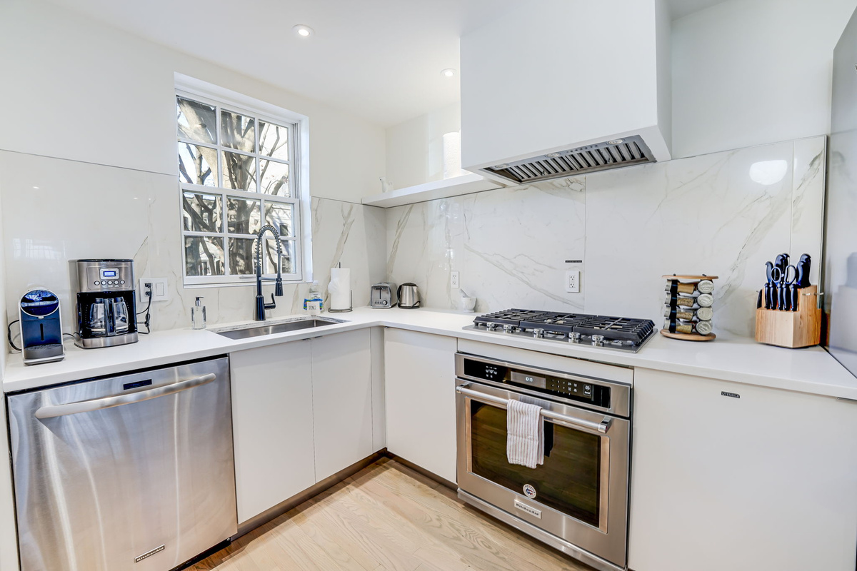 Kitchen: Stainless Steel KitchenAid Appliances, Gas Cooktop & Vent Hood.