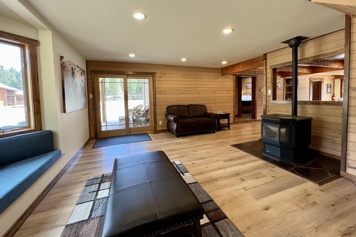 Living room off of kitchen with pellet stove and reading nook