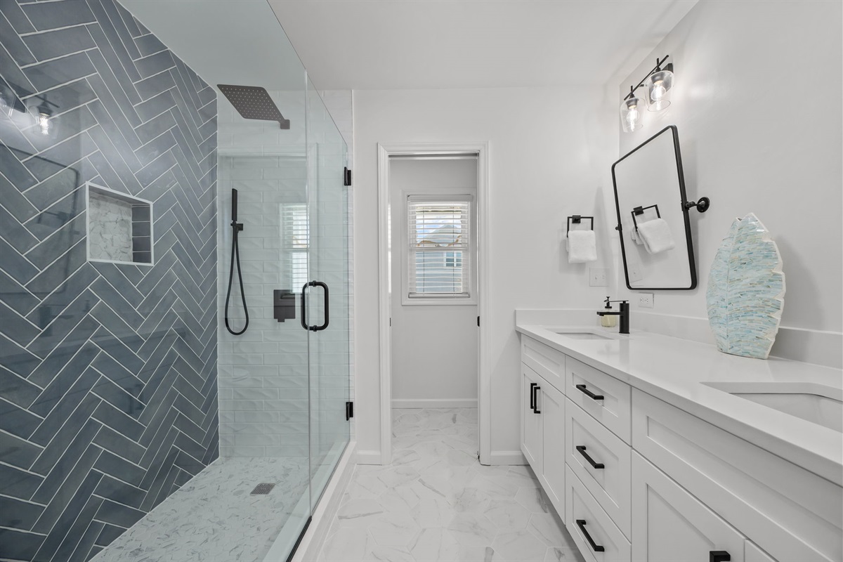 First floor master bathroom with double vanity and large walk-in shower